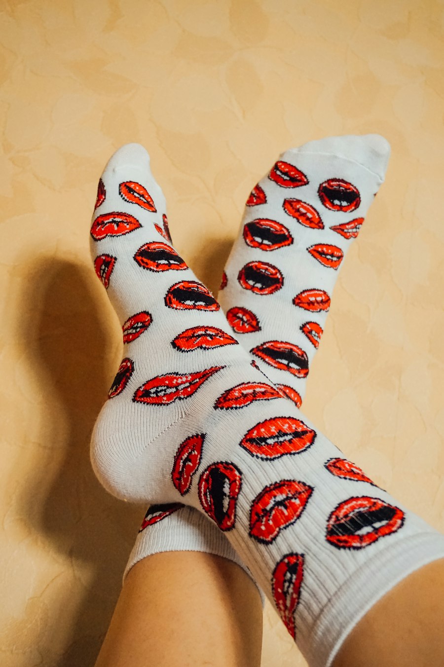 Custom printed crew socks worn with crossed feet, showing the all-over print style
